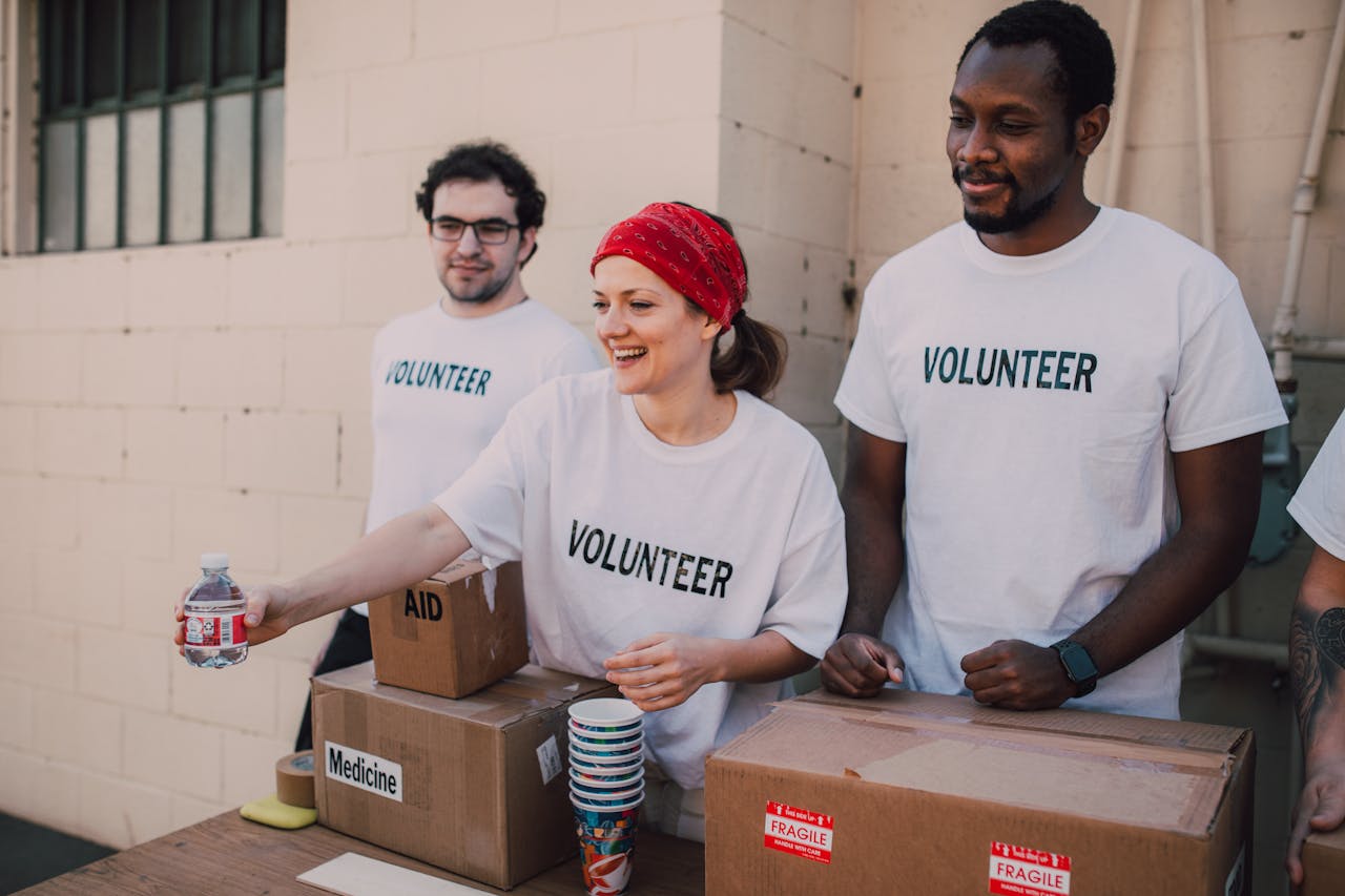 Home Volunteers distributing aid at an outdoor donation center, promoting social impact and diversity.